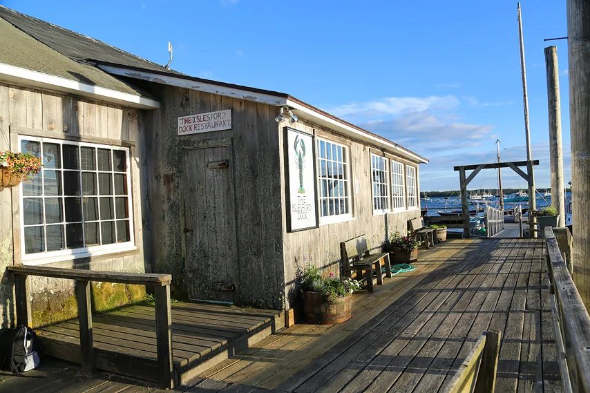 Weathered shingle exterior of Islesford Dock Restaurant beside the harbor