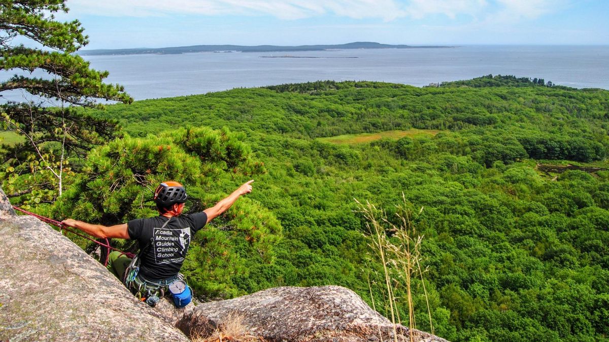 Rock climber on a granite cliff in Acadia